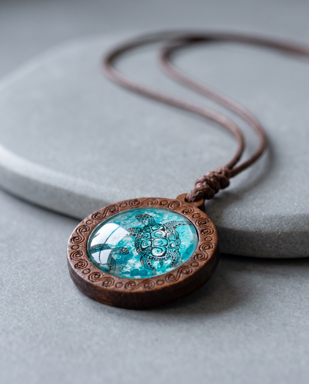 Maori Hawksbill Sea Turtle Necklace on grey stone