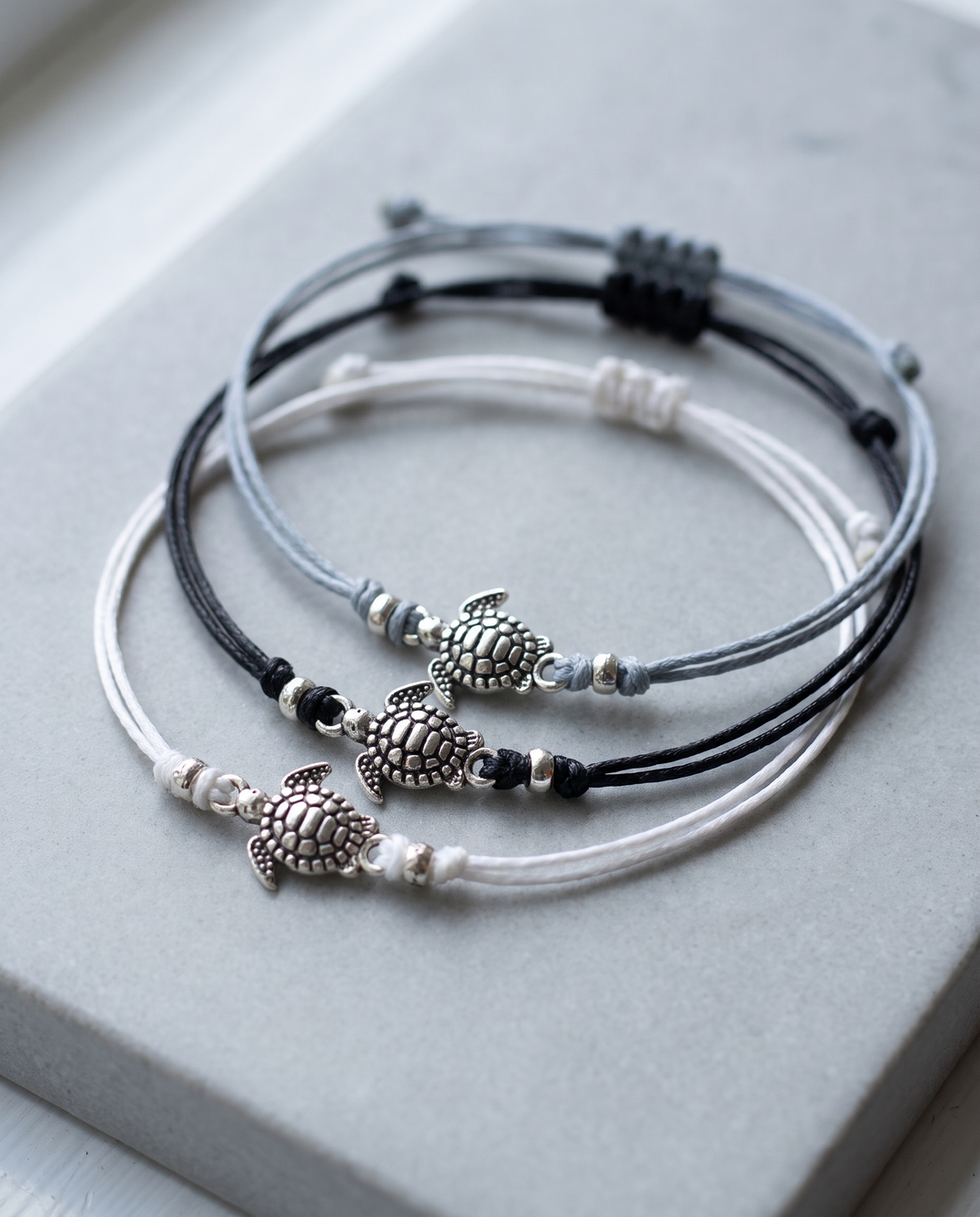 Baby Turtle Anklet Trio on grey stone