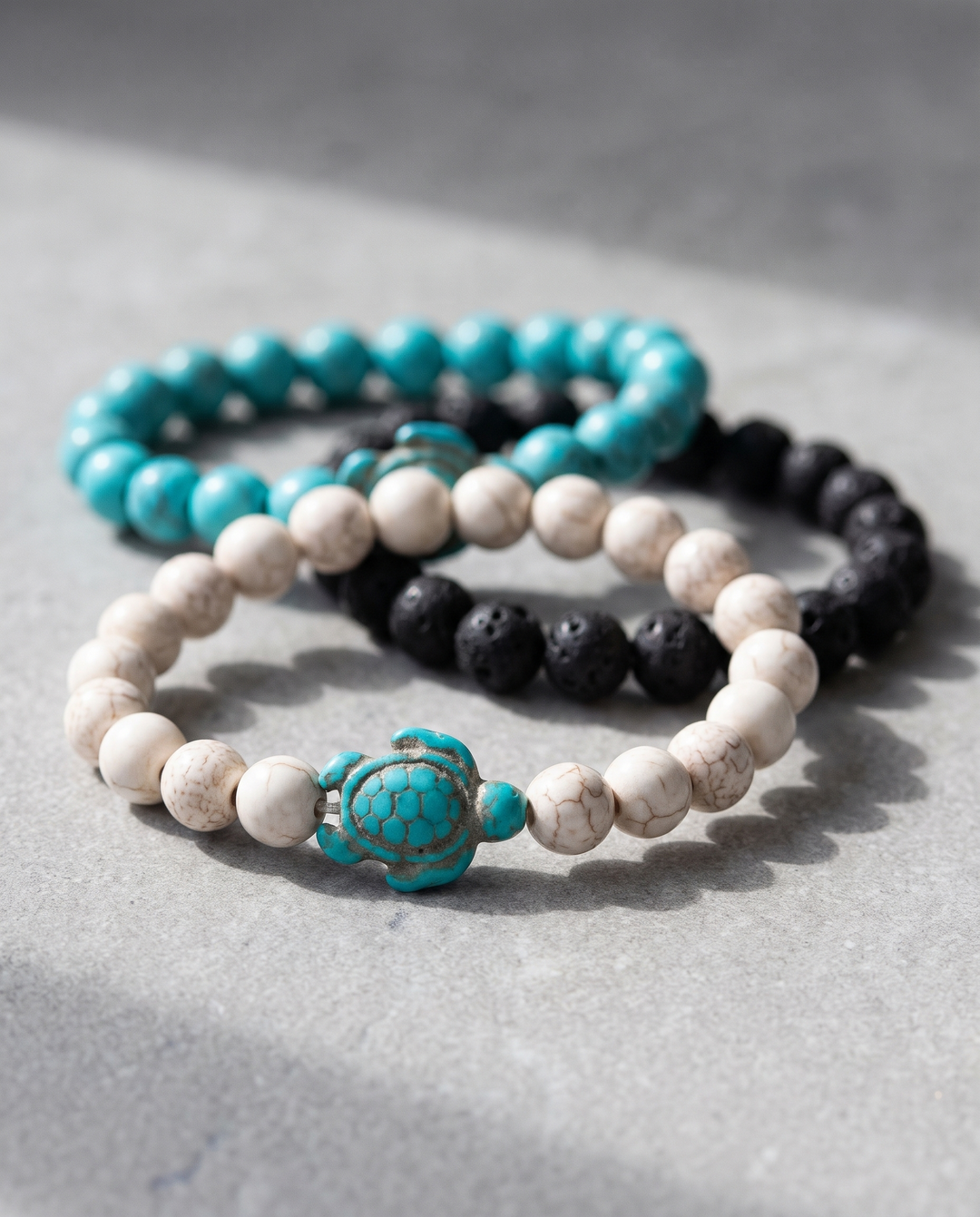 Rocky Trio bracelets on grey stone