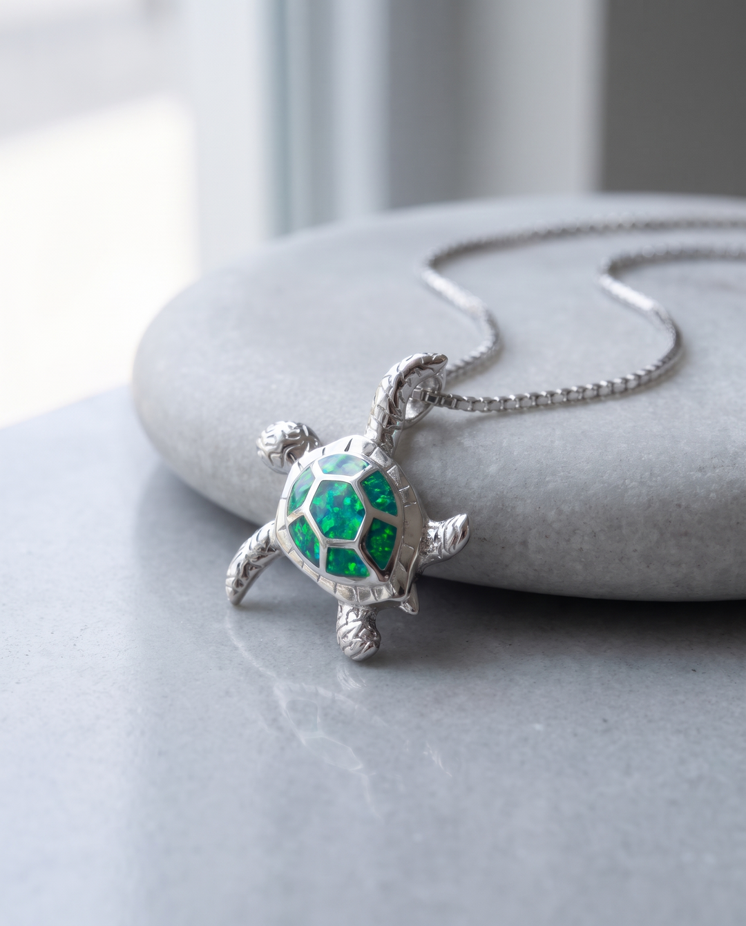 The Voyage Necklace on grey stone