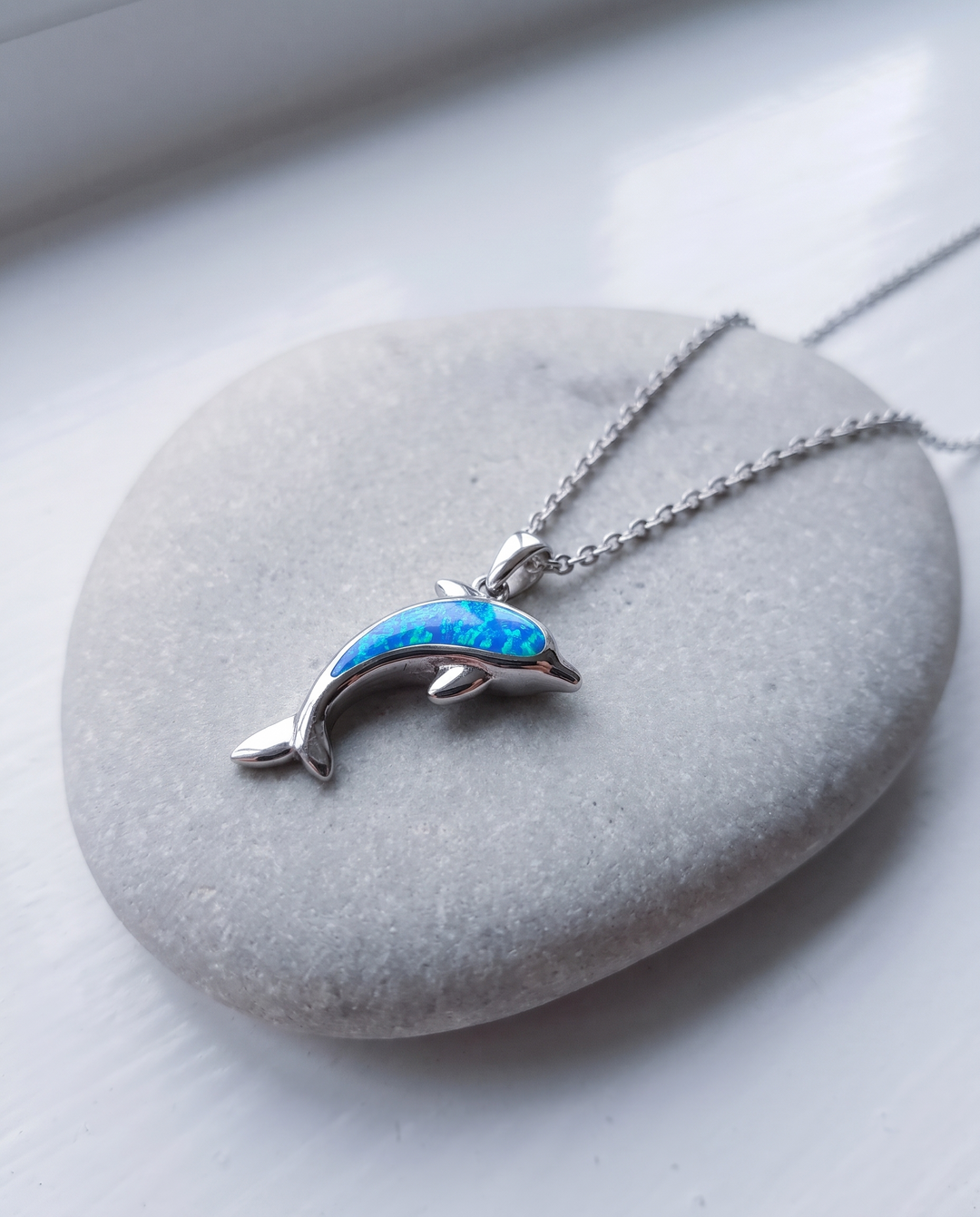 Dolphin Necklace on grey stone
