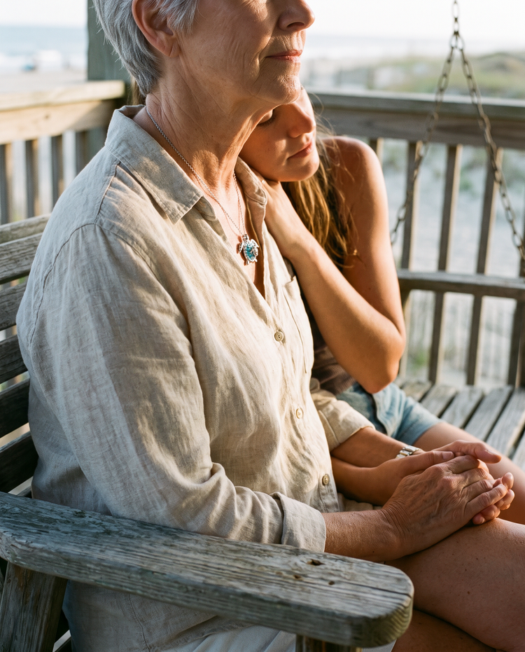 Mother and daughter, the mother wearing the Turtle Mother and Baby Necklace
