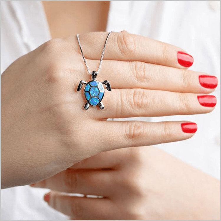 Person holding sea turtle necklace